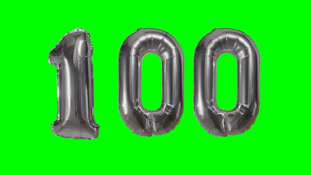 Number 100 one hundred years birthday anniversary silver balloon floating on green screen