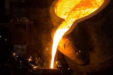 metal casting process with red high temperature fire in metal part factory