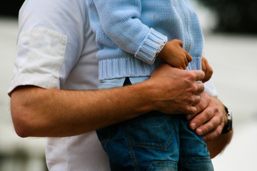 Intimate gesture of trust between a father and his son - obrazy, fototapety, plakaty