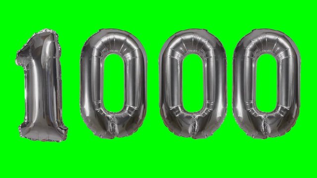 Number 1000 one thousand years birthday anniversary silver balloon floating on green screen