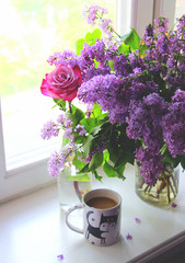  Fragrant spring bouquet of fresh lilacs on the window.