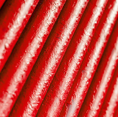 Many old red pipes. Pipeline used in different industry ways: gas, water or vapor supply. Close up
