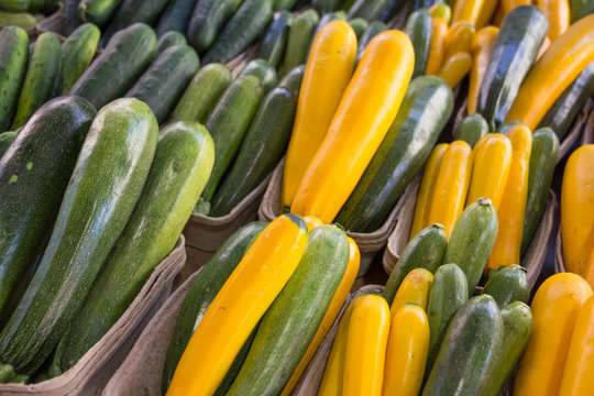 Zucchini And Yellow Squash In Cartons At A Farmers Market