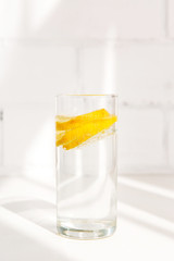 glass of water with a lemon and a measuring tape on a background,Healthy lifestyle and weight loss concept, body cleansing