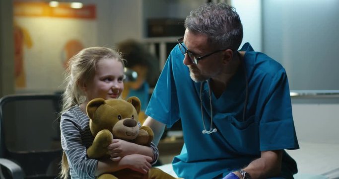 Friendly Doctor Talking With Girl