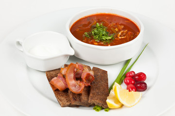 Soup saltwort with lemon, meat, pickles ead. With bacon and toast on white background.