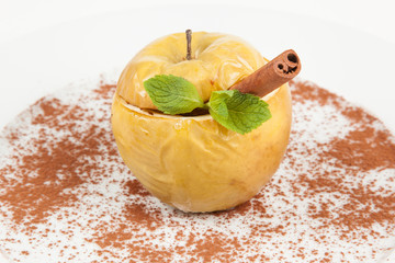 Baked apple. With cinnamon stick and mint leaf