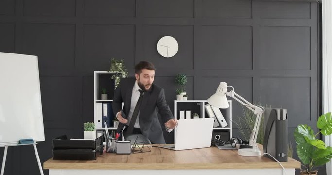 Businessman singing and dancing at office