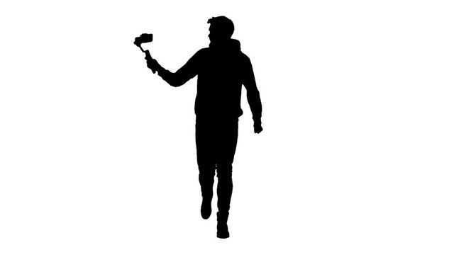 Cameraman's silhouette shooting himself while running using steadicam and smartphone.