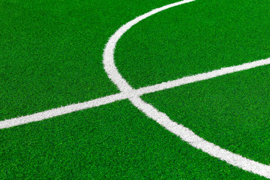 Painted White Lines And Fragment Of Circle On Green Artificial Turf On Soccer Field. Center Of Football Fiels.