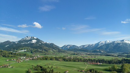 Fototapeta na wymiar Panormic view of beautiful landscape in Bavaria with alp mountains and blue sky