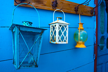 Samos island. Greece. Samos Kokkari Village. Colorful wall and blue, white, yellow lanterns.
