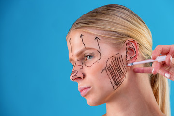 face of a girl with smooth skin without wrinkles makes beauty shots. Syringe next to the face, skin...