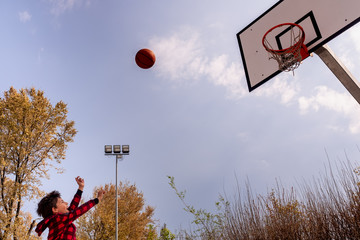 An enthusiastic child makes a basketball shot