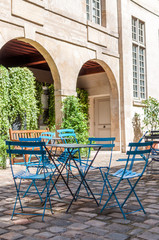 Parisian cafe terrace in the cobbled streets of old Paris - Paris, France