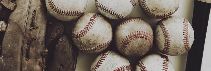 Vintage style baseball banner, balls and old used glove close up in detail for sport concept.