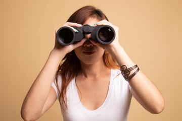 Young Asian woman with binoculars.