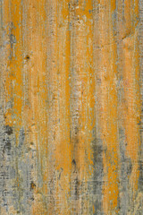 Rusty sheet of corrugated metal wall, as an orange textured background