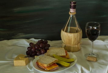 Wine and Fruit Still Life with Prosciutto Ham Sandwich in Artistic Setting