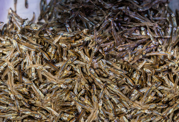 Hong Kong, China - March 8, 2019: Tai Po Market in New Territory. Large heap of brown and golden dried and smoked ansjovis.