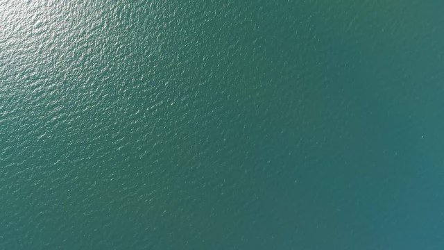 Aerial top down view from high altitude of green sea water texture