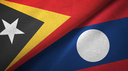 Fototapeta premium East Timor and Laos two flags textile cloth.