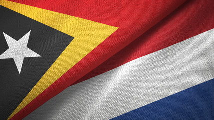 East Timor and Netherlands two flags textile cloth, fabric texture