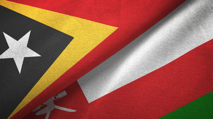 Fototapeta premium East Timor and Oman two flags textile cloth, fabric texture