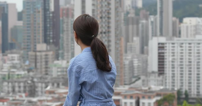 Woman look the city view in Hong Kong