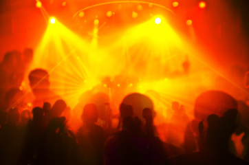 Fototapeta na wymiar Abstract blur Light And Silhouette hands of audience crowd people enjoying the club party with concert. Blurry night club DJ party people enjoy of music dancing sound.for Background.