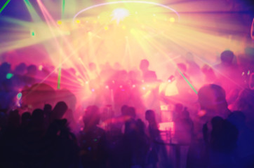 Fototapeta na wymiar Abstract blur Light And Silhouette hands of audience crowd people enjoying the club party with concert. Blurry night club DJ party people enjoy of music dancing sound.for Background.