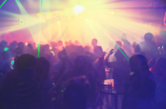Abstract blur Light And Silhouette hands of audience crowd people enjoying the club party with concert. Blurry night club DJ party people enjoy of music dancing sound.for Background.