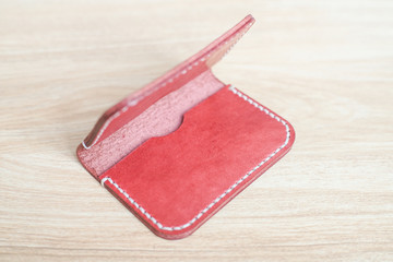 Red brown leather card holder on wood
