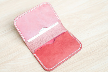 Red brown leather card holder on wood
