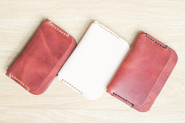 Red brown leather card holder on wood