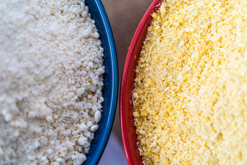 Red and Yellow Garri in bowls on Table top