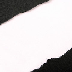 Torn black paper strip diagonal white background square