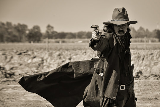 Vintage photos, of men wearing cowboy outfits and showing fighting with guns