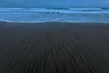 Textured, wet sand at a lonely beach