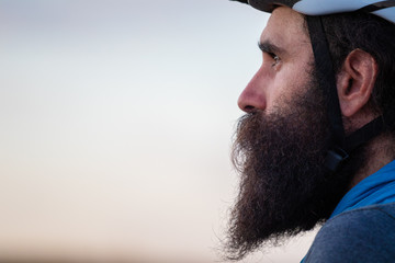 Young caucasian bearded man wearing a bike helmet