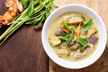 Thai green curry chicken (Kang Keaw Wan Kai) in a bowl on wooden, Thai food
