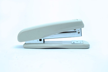 Office stationary Gray stapler with pile of staples