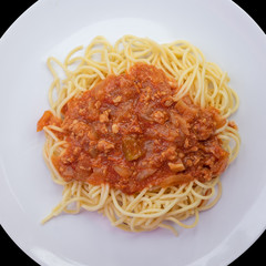 Spaghetti with tomato sauce in dish white.