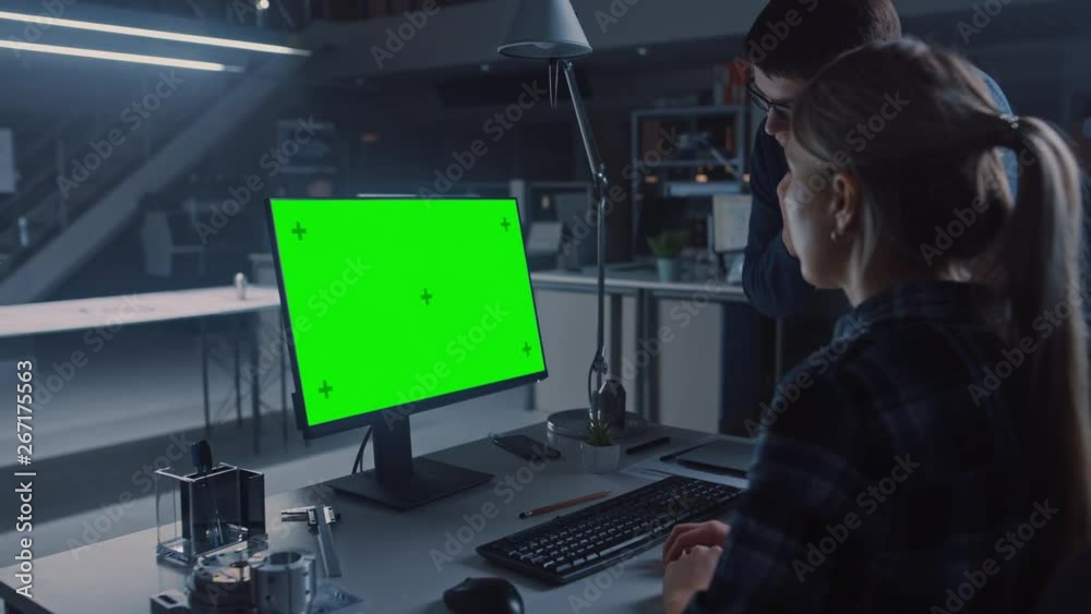 Aufkleber Engineer Working on Desktop Computer, Screen Showing Green Mock-up Screen, Her Male Project Manager Explains Project Specifics. Industrial Design Engineering Facility Office