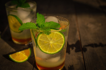 Fresh Ice Honey Lemon soda drink on the wood table there are lemon slice and same object placed back side.