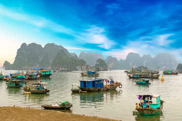 Fototapeta na wymiar Cat Ba Harbor in Halong Bay, Vietnam with many fishing boats anchored. This is considered a natural World Heritage Site