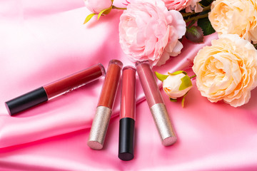 Obraz na płótnie Canvas Cosmetics,makeup lipstics products with pink rose