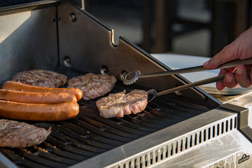 Flipping or Burning Burned Juicy Steaks Sizzle on Flaming and Smoking Grill.