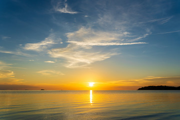 Colorful sunset over calm sea water near tropical beach. Summer vacation concept. Island Phangan, Thailand