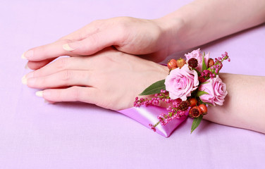 Wrist corsage for autumn wedding.  Bouquet of pink roses and heather. © agneskantaruk